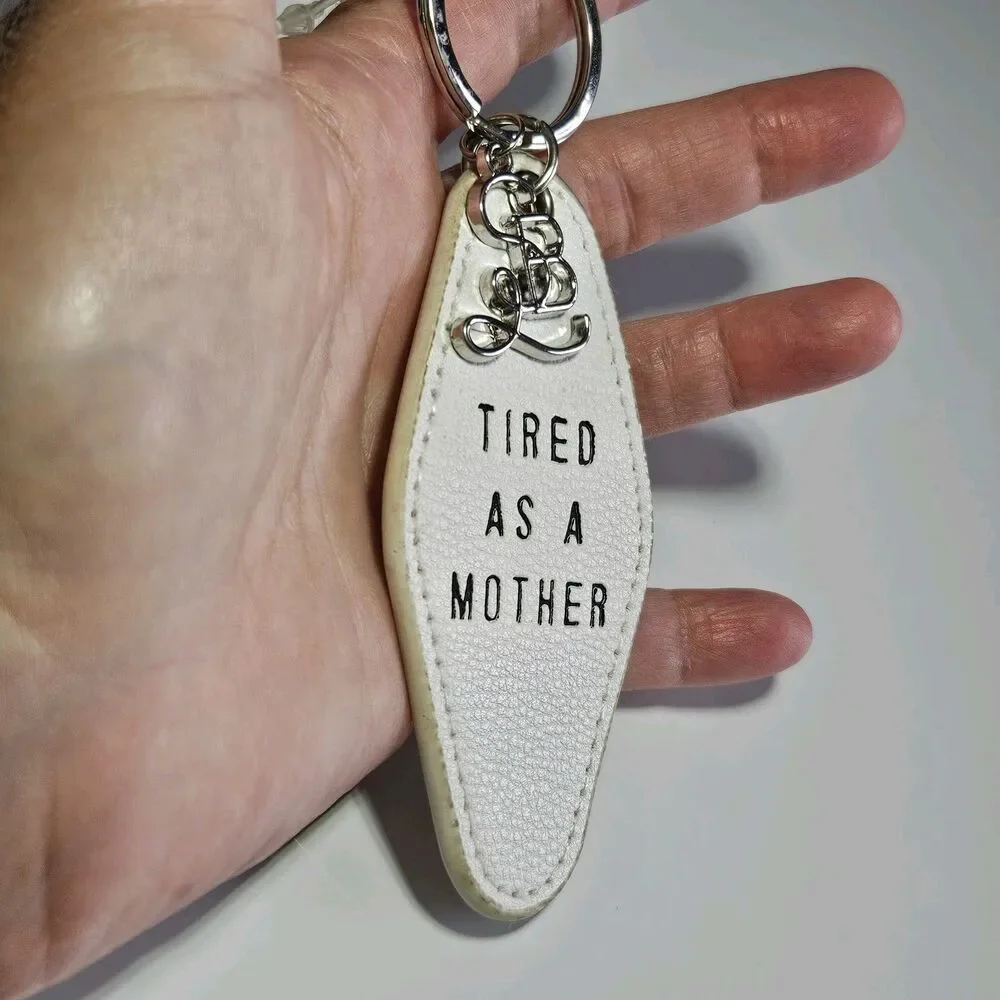 Santa Barbara Design Studio Silver Tone White Leather Tired As A Mother Keychain
